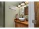 Rustic powder room with wood accents, vessel sink, and charming decor for guests at 3636-A Holly Grove Rd, Dunn, NC 28334