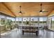 Bright sunroom with ample windows providing stunning lake views, wood ceiling and fan, perfect for relaxation at 3636-A Holly Grove Rd, Dunn, NC 28334