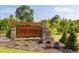 Stone sign at The Farm at Neill's Creek entrance with beautiful landscaping at 364 Peach Grove Way, Lillington, NC 27546