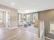 Upstairs living area features light hardwood floors, neutral paint, natural light, and a comfortable seating area at 364 Peach Grove Way, Lillington, NC 27546