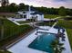 Beautiful aerial view of the property with a large pool, patio, and manicured lawns at 4001 Campbell Rd, Raleigh, NC 27606