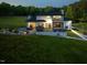 Back exterior of home with large deck, patio and lush landscaping at 4001 Campbell Rd, Raleigh, NC 27606