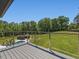 Expansive backyard view from the back deck with in-ground pool, pool house and manicured landscaping at 4001 Campbell Rd, Raleigh, NC 27606
