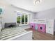 Comfortable bedroom with a bunkbed, striped daybed and large window with lake views at 4001 Campbell Rd, Raleigh, NC 27606