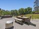 An outdoor deck area featuring outdoor seating, a dining table, and a lush green yard at 4001 Campbell Rd, Raleigh, NC 27606