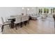 Elegant dining room featuring a wooden table with seating for eight, a comfortable sofa, and large windows at 4001 Campbell Rd, Raleigh, NC 27606
