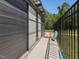 Pool house exterior with large sliding glass door and fenced walkway at 4001 Campbell Rd, Raleigh, NC 27606