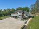Elegant exterior of the home featuring a three-car garage, well-manicured landscaping, and a spacious driveway at 4001 Campbell Rd, Raleigh, NC 27606