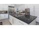 A kitchen featuring a large island with cooktop and stainless steel appliances at 4001 Campbell Rd, Raleigh, NC 27606
