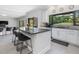 Open kitchen with large island, black counter tops and view to the outside at 4001 Campbell Rd, Raleigh, NC 27606
