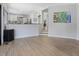 An open-concept living space with hardwood floors and access to kitchen at 4001 Campbell Rd, Raleigh, NC 27606
