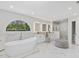 A luxurious main bathroom with a soaking tub, dual vanities and a glass enclosed walk-in shower at 4001 Campbell Rd, Raleigh, NC 27606