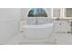A luxurious main bathroom with a soaking tub, vanity, and modern fixtures at 4001 Campbell Rd, Raleigh, NC 27606