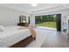 Bright main bedroom boasting hardwood floors and black framed sliding doors to an open private yard at 4001 Campbell Rd, Raleigh, NC 27606