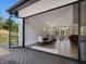 Open floorplan featuring a dining room with large sliding doors to a deck, a living room, and comfortable seating at 4001 Campbell Rd, Raleigh, NC 27606