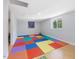 A playroom with colorful play mats and a bright window at 4001 Campbell Rd, Raleigh, NC 27606