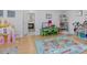 Bright playroom with hardwood floors, a toy castle, and a doorway leading to bathroom at 4001 Campbell Rd, Raleigh, NC 27606
