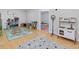 Spacious playroom features hardwood floors, neutral walls, and a play kitchen at 4001 Campbell Rd, Raleigh, NC 27606
