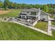 Expansive rear exterior featuring a deck with seating areas overlooking a vast lawn at 4001 Campbell Rd, Raleigh, NC 27606