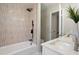 Updated bathroom featuring a tub, rain shower head, white vanity, and modern fixtures at 4204 Green Rd, Raleigh, NC 27604
