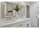 Modern bathroom featuring double sinks, quartz counters, two mirrors, and designer fixtures at 4204 Green Rd, Raleigh, NC 27604