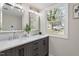 Modern bathroom features a double vanity, mirrors, and a large window at 4204 Green Rd, Raleigh, NC 27604