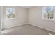 Bedroom with neutral carpet and two windows providing plenty of natural light at 4204 Green Rd, Raleigh, NC 27604