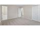 This carpeted bedroom has an ensuite bathroom, a closet and neutral paint at 4204 Green Rd, Raleigh, NC 27604