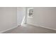 This carpeted bedroom features a large window and a closet for storage at 4204 Green Rd, Raleigh, NC 27604