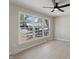 Bright bedroom with large windows, ceiling fan, and light wood laminate flooring at 4204 Green Rd, Raleigh, NC 27604