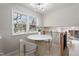 Sunlit breakfast nook features a marble table, two chairs, and a large window at 4204 Green Rd, Raleigh, NC 27604