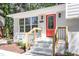 Close-up of the bright red front door and brick steps of the home, enhancing curb appeal at 4204 Green Rd, Raleigh, NC 27604