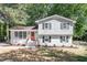 Charming two-story home boasts gray painted brick, white trim, red door, and landscaped yard at 4204 Green Rd, Raleigh, NC 27604