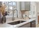 A modern kitchen sink with a brushed metal faucet sits beneath a bright window at 4204 Green Rd, Raleigh, NC 27604