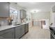 Modern kitchen with gray cabinets, stainless steel appliances, white countertops, and hardwood floors at 4204 Green Rd, Raleigh, NC 27604