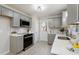 Updated kitchen features grey cabinets, stainless steel appliances, and white countertops at 4204 Green Rd, Raleigh, NC 27604