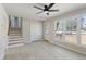 Bright living room with stairs, closet, and large windows at 4204 Green Rd, Raleigh, NC 27604