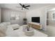 Inviting living room features a large window, sectional sofa, ceiling fan, and neutral decor at 4204 Green Rd, Raleigh, NC 27604