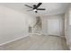 Open living room with staircase, closet, and new laminate floors at 4204 Green Rd, Raleigh, NC 27604