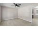 A brightly lit living room featuring new laminate floors and modern ceiling fan at 4204 Green Rd, Raleigh, NC 27604