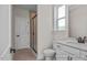 Bathroom features white vanity, toilet, and a shower with glass doors and a window at 436 Golden Dragonfly St, Wake Forest, NC 27587