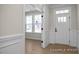 Bright entryway featuring clean white trim, with the front door and a living room with windows at 436 Golden Dragonfly St, Wake Forest, NC 27587