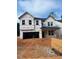 Exterior elevation of a new home with visible windows and a two-car garage under construction at 436 Golden Dragonfly St, Wake Forest, NC 27587