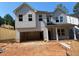New construction home with gray siding, double windows, and an attached two-car garage ready to be completed at 436 Golden Dragonfly St, Wake Forest, NC 27587