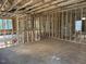 A view of the interior of a house being built with wooden frames, windows, and a staircase at 436 Golden Dragonfly St, Wake Forest, NC 27587