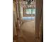 Inside the home, unfinished wood framing highlights future rooms with windows showing outdoor greenery at 436 Golden Dragonfly St, Wake Forest, NC 27587