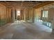 Unfinished living room with exposed wood framing, multiple windows, and open layout at 436 Golden Dragonfly St, Wake Forest, NC 27587