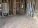 Unfinished living space with visible framing, HVAC unit, and open layout for a modern home design at 436 Golden Dragonfly St, Wake Forest, NC 27587