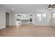 Bright and airy living space open to the modern kitchen featuring wood floors, with a large island at 436 Golden Dragonfly St, Wake Forest, NC 27587