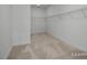 Walk-in closet with carpet flooring and built-in shelving, maximizing storage space and organization at 436 Golden Dragonfly St, Wake Forest, NC 27587
